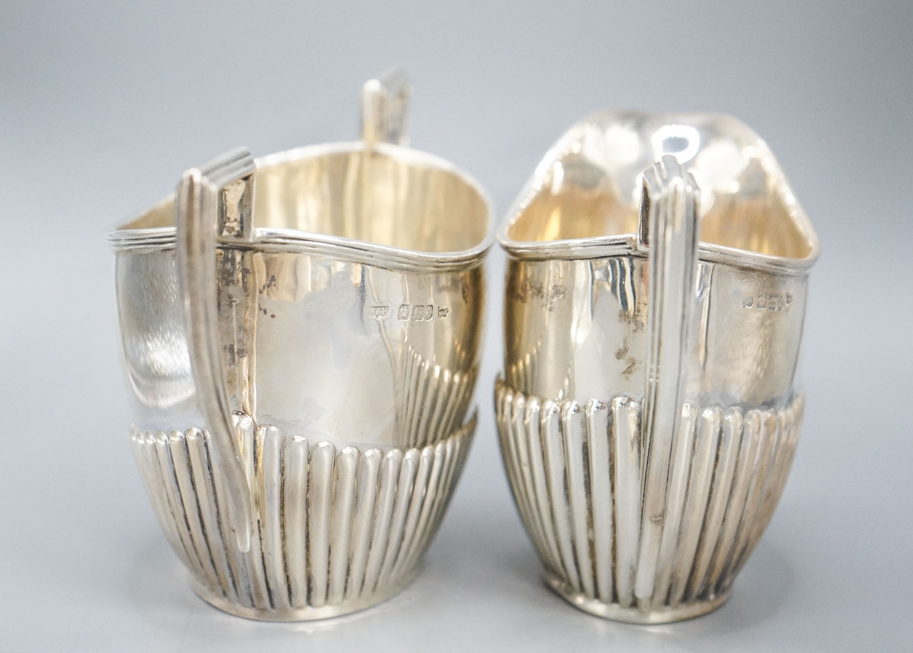 A late Victorian fluted silver cream jug and matching sugar bowl, by Walker & Hall, Sheffield, 1892/3, 13oz.